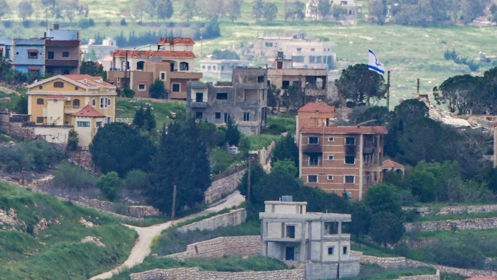 An Israeli flag hangs on a building in Southern Lebanon, as seen from the Israeli side of the border, April 20, 2026. Photo by Ayal Margolin/Flash90.