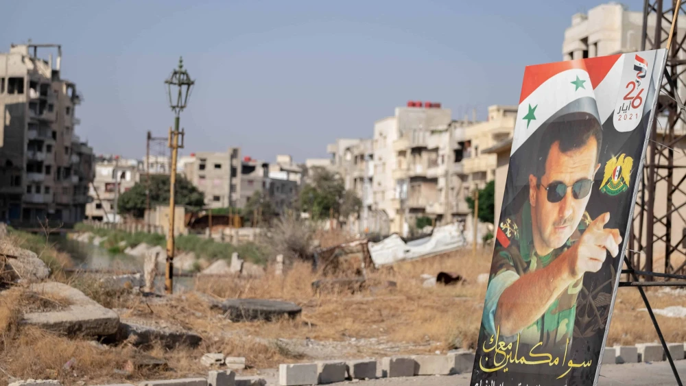 A poster of President Bashar Assad in Homs's destroyed city center during the Syrian civil war, Aug. 25, 2021. Photo by Lena Ha/Shutterstock.