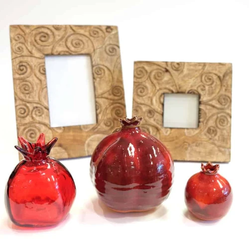 Glass pomegranates and hand-carved frames made in India. Credit: Dayenu.