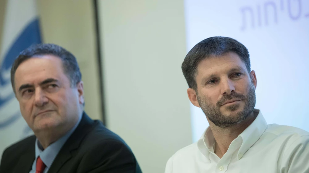 Betzalel Smotrich and Israel Katz during a ceremony at the Ministry of Transport and Road Safety, in Jerusalem, June 23, 2019. Photo by Noam Revkin Fenton/Flash90.