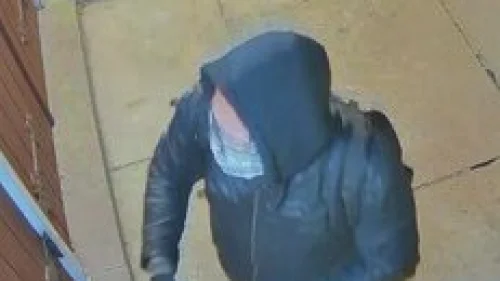 Surveillance video shows a man placing stickers, including some with an image of Adolf Hitler, on the Beth Isaiah Synagogue in Guelph, Ontario, Oct. 5, 2022. Credit: Guelph Police Service.