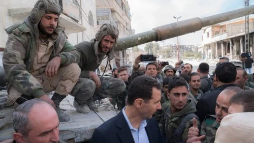 Syrian President Bashar Assad (center front) in Ghouta on March 18, 2018. Credit: Syrian President’s Office-JCPA.