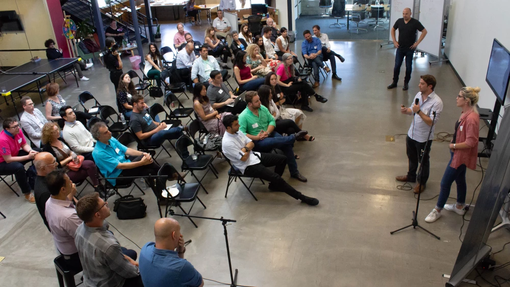 Ron Biton and Shiran Schmerling, participants in the IDEAS Immersion program, present their startup platforms to L.A.-based companies and the community. Credit: Harmony Wedding Photography.