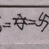 Anti-Semitic graffiti equating Judaism with Nazism and money, found in Madrid in 2003. Credit: Wikimedia Commons.