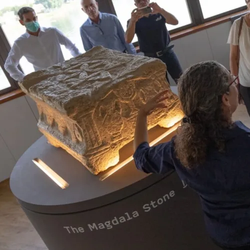 Einat Ambar Armon, curator of the Sanhedrin Trail exhibition on behalf of the Israel Antiquities Authority, presents the Magdala Stone. Photo by Yair Amitzur/Israel Antiquities Authority.