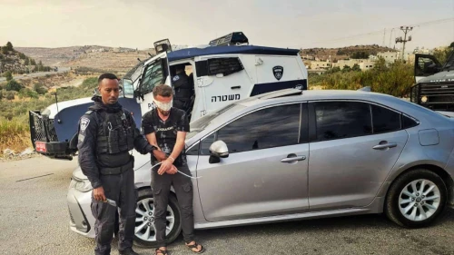 An Israeli police officer detains a Palestinian suspect in an undisclosed location in Judea and Samaria, as part of the law enforcement operation “Stopping at Red,” carried out in August, 2025. Credit: Israel Police.