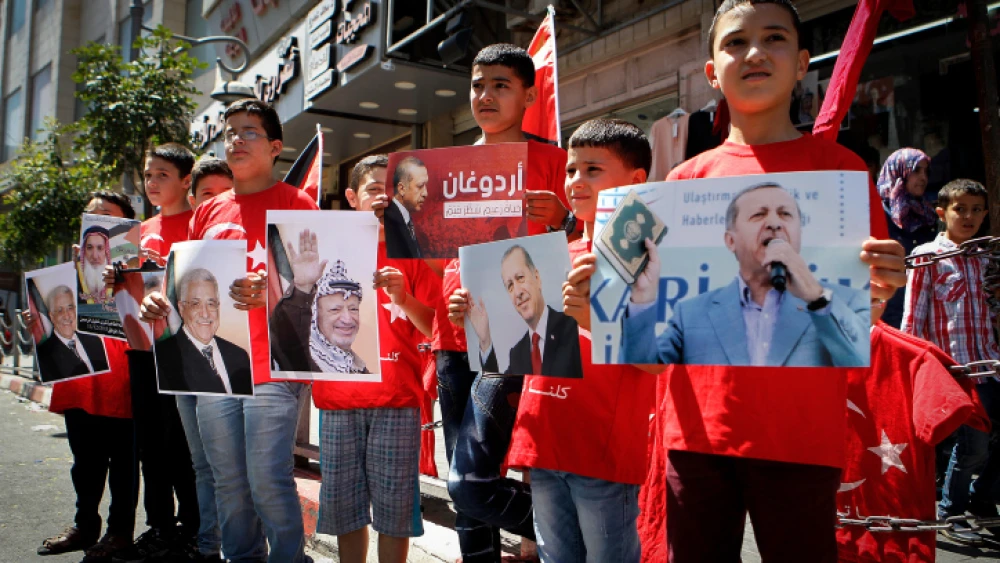 Palestinians holds pictures of Turkish President Recep Tayyip Erdoğan as they wear shirts with Turkish flags in the West bank city of Hebron July 20, 2016. Photo By Wisam Hashlamoun/Flash90.