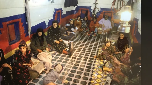 A Yemenite Jewish family in the multifunction room of their home, which would be used for sleeping, eating and entertaining. Photo from a 2018 exhibit in New York City. Credit: Shiryn Solny/JNS.