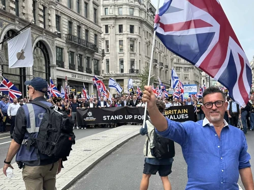 Lance Forman, a Jewish businessman from London and a former member of the European Parliament, waves a British flag at the Campaign Against Antisemitism's march in London on Sept. 7, 2025. Credit: Courtesy of Lance Forman.