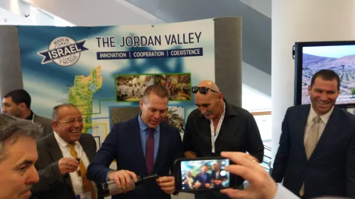 Minister of Strategic Affairs pours wine from Judea and Samaria at Israel Kongress in Frankfurt, together with the head of the Jordan Valley Regional Council David Elhayani and Palestinian human-rights activist Baseem Eid. Credit: Jordan Valley Regional Council.