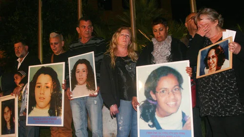 Relatives of the seven Israeli schoolgirls killed by Jordanian terrorist Ahmed Daqamseh in 1997 hold photos of the victims during a demonstration in front of the Jordanian Embassy in Ramat Gan, Israel. Credit: Flash90.