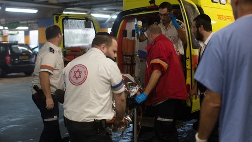 Click photo to download. Caption: Paramedics wheel a wounded Israeli man into the emergency room of the Shaare Zedek Medical Center on Nov. 6, 2015, after he was stabbed by a Palestinian attacker in the Sha'ar Binyamin industrial park in Judea and Samaria. Credit: Yonatan Sindel/Flash90.