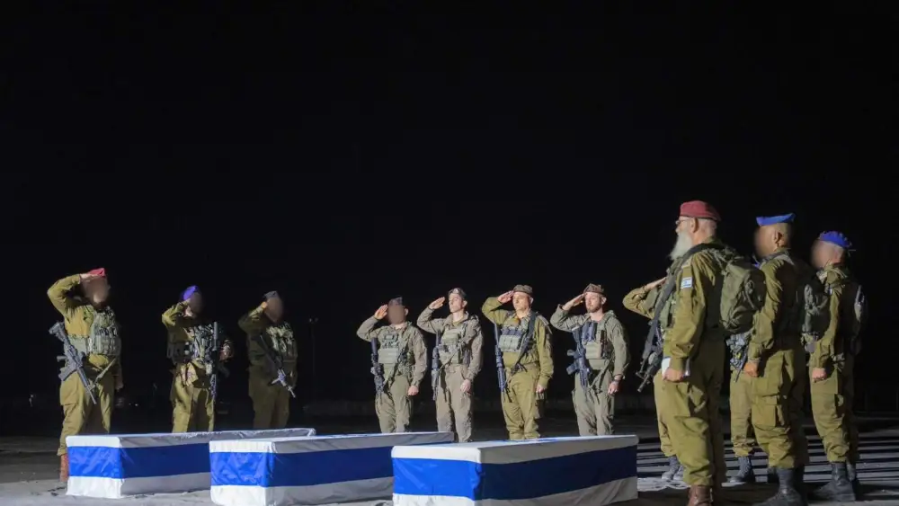 Three coffins draped in Israeli flags are surrounded by IDF soldiers standing at attention, paying tribute to the fallen hostages during a solemn ceremony in Israel on Nov. 2, 2025. Credit: IDF.
