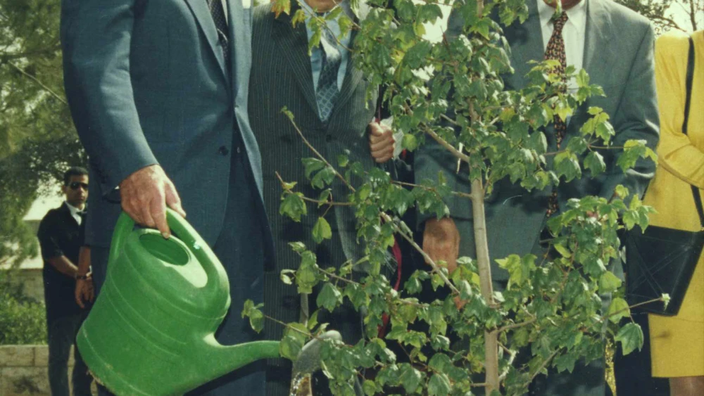 Prince Philip waters a maple tree in memory of his mother, Princess Alice at Yad Vashem in Jerusalem, Oct. 31, 1994. Credit: Beni Birk/The National Library of Israel.