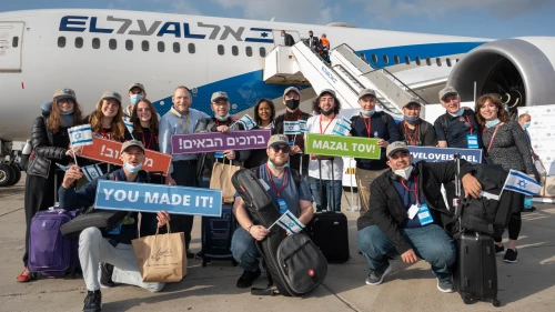 Israeli Aliyah and Integration Minister Pnina Tamano-Shata (back row, seventh from the right) welcomes new immigrants from North America at Ben-Gurion International Airport, April 26, 2021. Credit: Nefesh B'Nefesh.