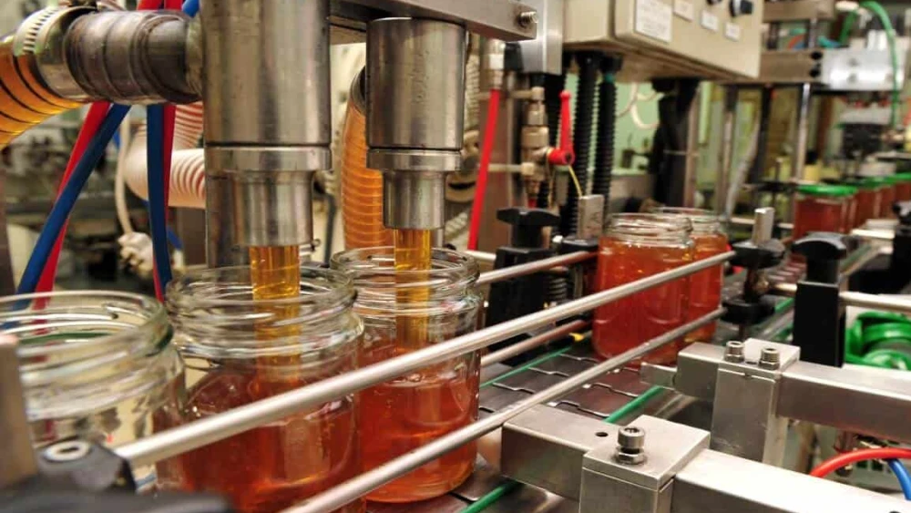 Jars of Yad Mordechai honey leave the production line. Photo courtesy of Strauss
