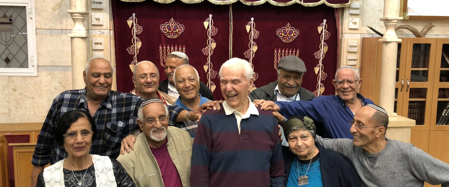 Capt. Elgen Long is embraced by Yemenite Jews during a visit to Israel last fall. Credit: Shahar Azani.
