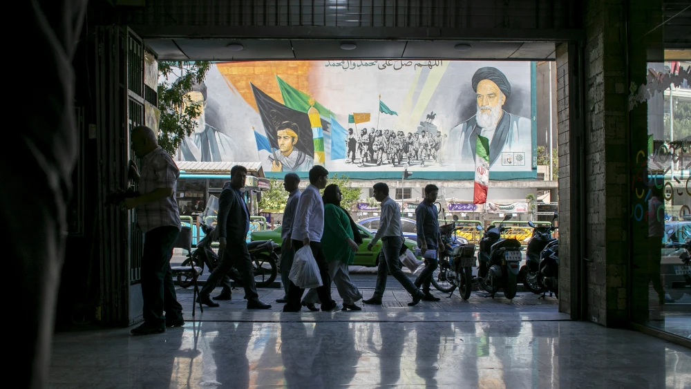 Pedestrians walk in Tehran near a poster depicting former Iranian supreme leaders during the ceasefire in fighting against the United States and Israel, May 9, 2026. Photo by Majid Saeedi/Getty Images.