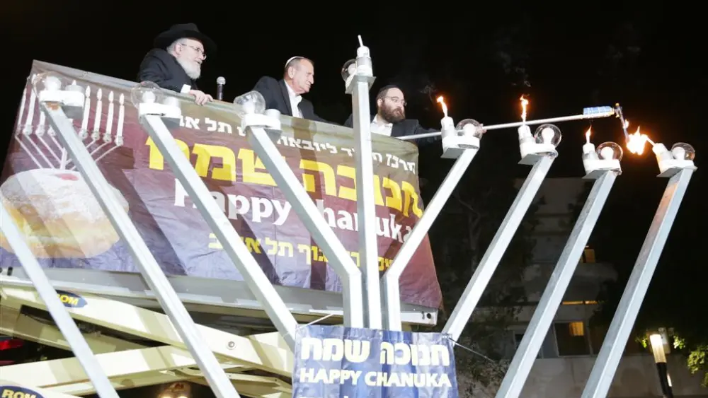 Ron Huldai, the mayor of Tel Aviv-Yafo, inaugurated the renewed Dizengoff Square in Tel Aviv by lighting the fourth Hanukkah candle of the central Chabad menorah, together with Rabbi Joseph Gerlitzky. Dec. 5, 2018.