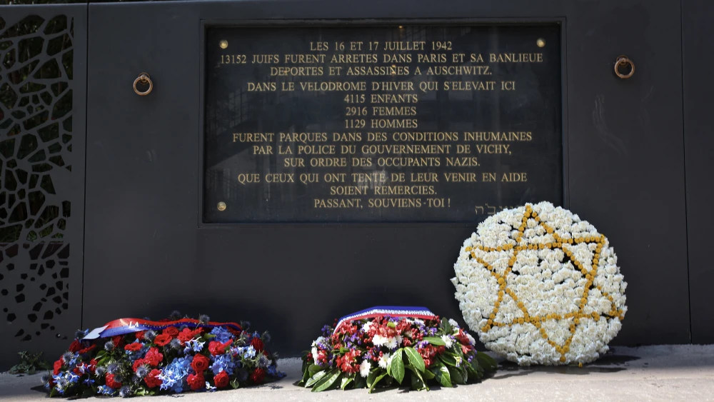 Wreaths of flowers are placed near a plaque commemorating the Vélodrome d'Hiver (Vél d'Hiv) roundup during a National Day ceremony in Paris, July 20, 2025. Photo by Daniel Perron/Hans Lucas via AFP via Getty Images.