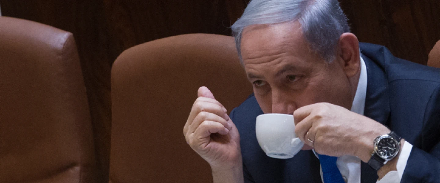 Israeli Prime Minister Benjamin Netanyahu seen drinking coffee during a plenum session in the assembly hall of the Israeli parliament on June 17, 2015. Photo by Miriam Alster/Flash90.
