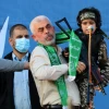 Hamas chief in Gaza Yahya Sinwar holds a boy dressed as a Hamas terrorist during a rally in Gaza City, May 24, 2021. Photo by Atia Mohammed/Flash90.