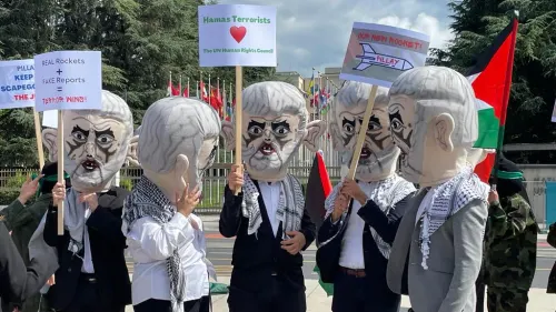 Israel Defense Forces reservists protest outside the U.N. Human Rights Council in Geneva, costumed as terrorists to “thank” the council for its anti-Israel bias in a demonstration organized by the Tel Aviv-based Shurat HaDin Law Center on June 7, 2022. Credit: Courtesy.