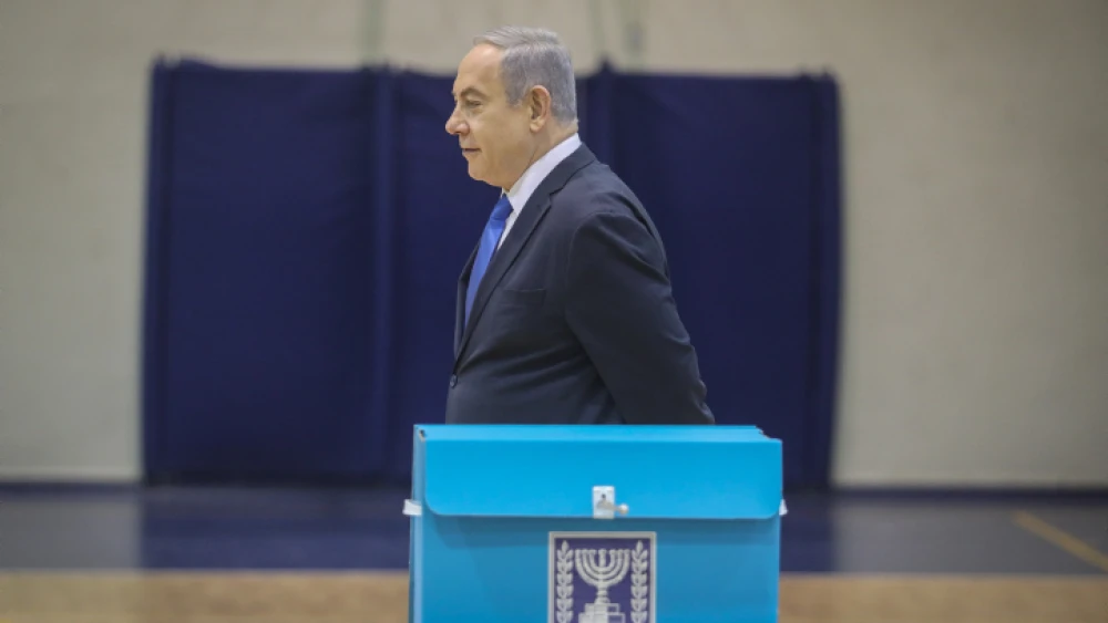 Israeli Prime Minister Benjamin Netanyahu casts his ballot at a voting station in Jerusalem on March 2, 2020. Photo by Marc Israel Sellem/POOL.