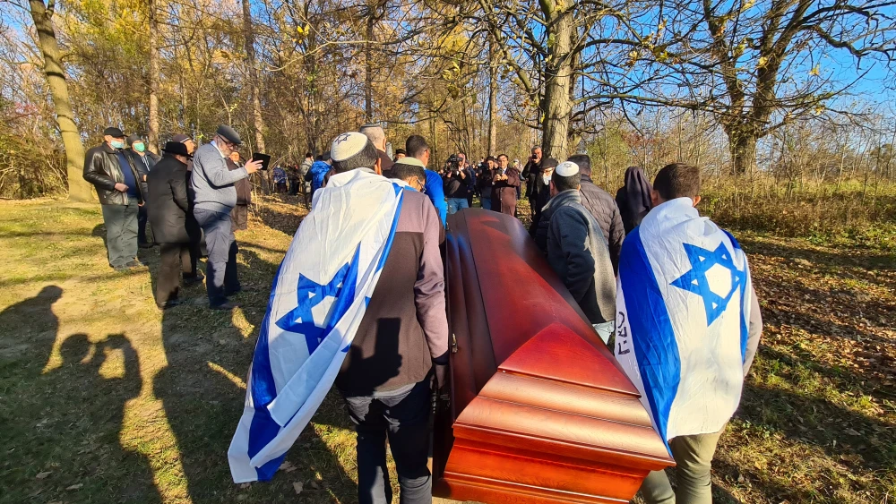 AMIT students carry the coffin of Jaffa's Catholic Priest, Gzregorz Pawlowski (Jacob Hirsch Griner) to its final resting place alongside the Izbica mass-grave that Griner's mother, sisters and 1,000 other Jewish victims were shot and killed in 1942 during the Holocaust. Credit: AMIT