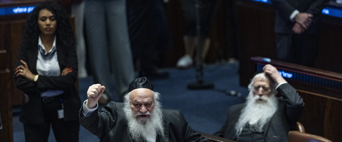 MK Yitzhak Goldknopf, government ministers and members of Knesset attend a plenum session and a vote on a bill to freeze arrests of Haredi draft evaders in the Knesset, July 14, 2026. Photo by Chaim Goldberg/Flash90.