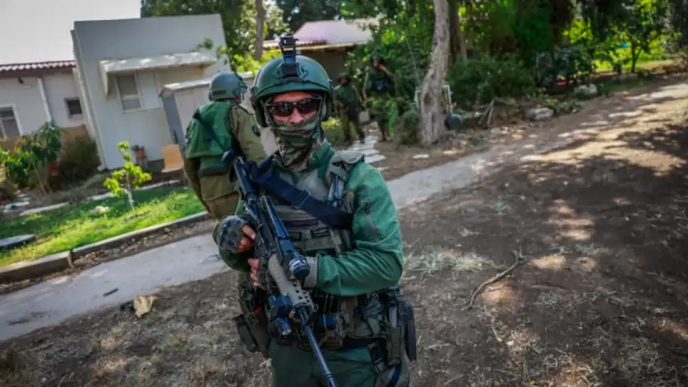Israeli soldiers around the destruction caused by Hamas Militants in Kibbutz Kfar Aza, near the Israeli-Gaza border, in southern Israel, October 10, 2023. Photo by Chaim Goldberg/Flash90 *** Local Caption *** ??? ????? ??? ???? ?????? ????? ????? ??? ??? ????? ??? ????? ????