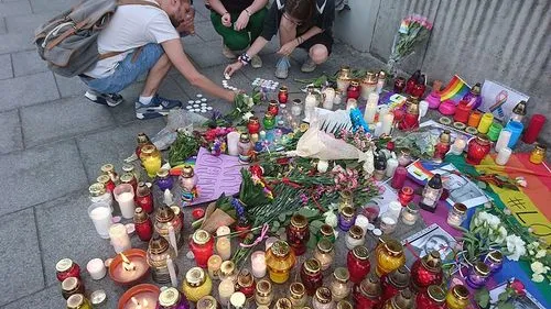 Click photo to download. Caption: A memorial display for the Orlando shooting victims in Warsaw, Poland. Credit: Wikimedia Commons.