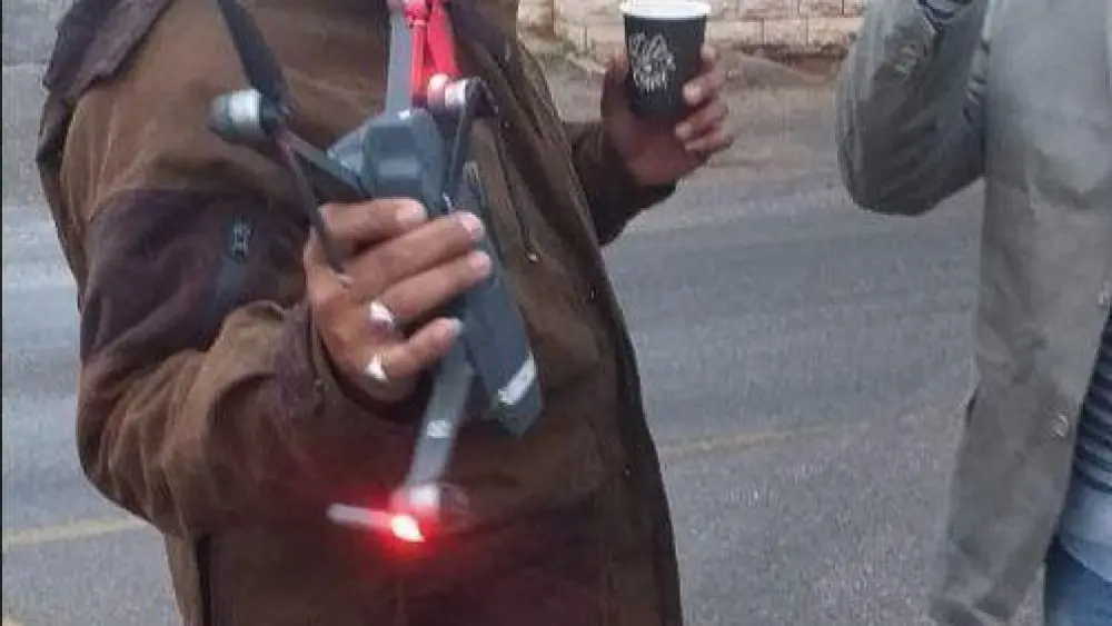 A Lebanese man holds an Israeli drone he allegedly shot down in southern Lebanon, Oct. 23, 2019. Source: Screenshot.