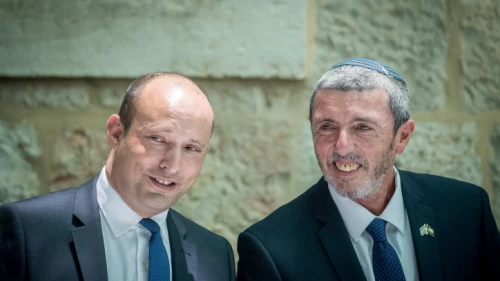 Outgoing Israeli Education Minister Naftali Bennett speaks with newly appointed Education Minister Rabbi Rafi Peretz during a ceremony in Jerusalem on June 26, 2019. Photo by Yonatan Sindel/Flash90.