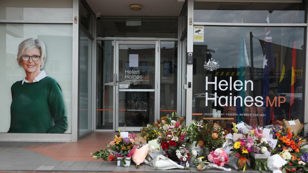 Floral tributes are placed outside the offices of Australian lawmaker Helen Haines who was critically wounded in a "targeted" attack, in Wangaratta on Oct. 21, 2026. Photo by Martin Keep/AFP via Getty Images.