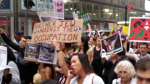 An anti-Israel demonstration in Manhattan's Columbus Circle, including a Jewish anti-Zionist sign reading, “Another Jew Against the Occupation.” Credit: Ben Cohen.