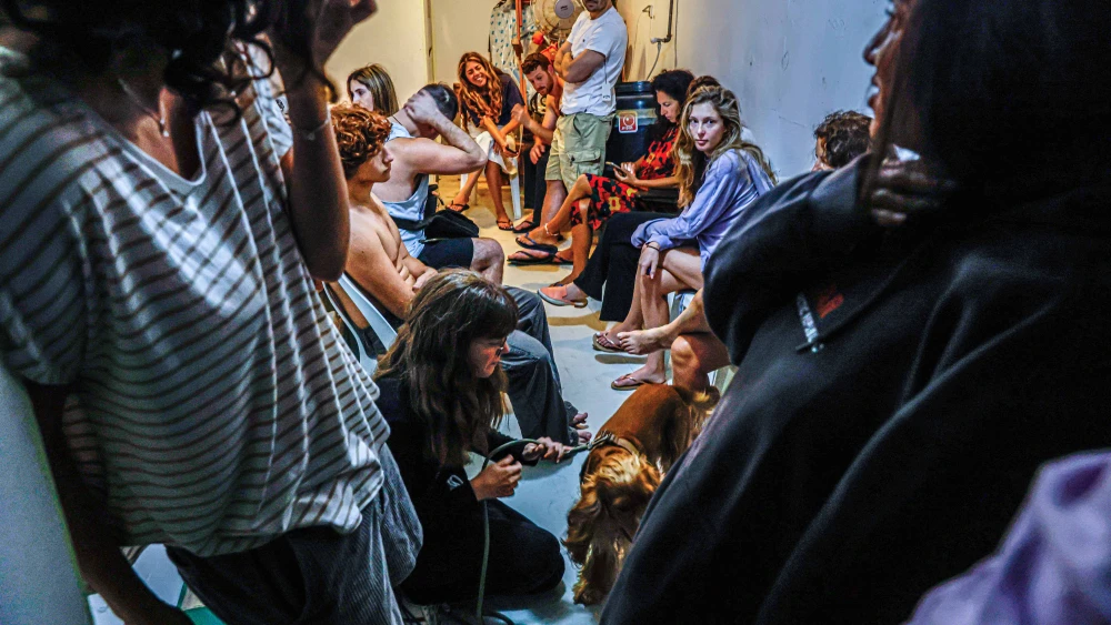 Israelis take cover inside a bomb shelter as a rocket alert is activated in Tel Aviv, Oct. 22, 2024. Photo by Yehoshua Yosef/Flash90.