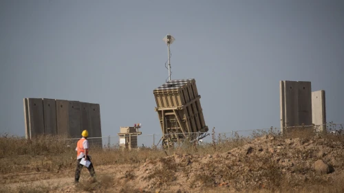 A man walks near an Iron Dome missile-defense system near the city of Sderot in southern Israel on May 29, 2018. Photo by Yonatan Sindel/Flash90.