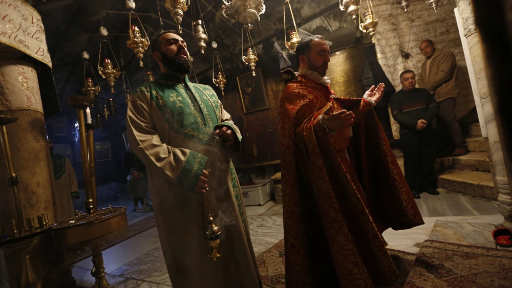 Christian clergymen pray inside the Church of Nativity in the city of Bethlehem a few days before the Christmas holiday, Dec. 23, 2018. Credit: Wisam Hashlamoun/Flash90.