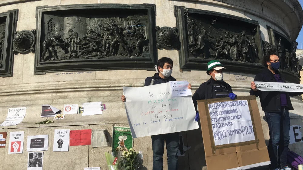Protesters wave banners reading "We are Prof" in solidarity with murdered teacher Samuel Paty, who was beheaded on Oct. 15, 2020 in Paris for showing a cartoon of the prophet Muhammad in a course on free speech. Source: Twitter/Sophie Sassi.