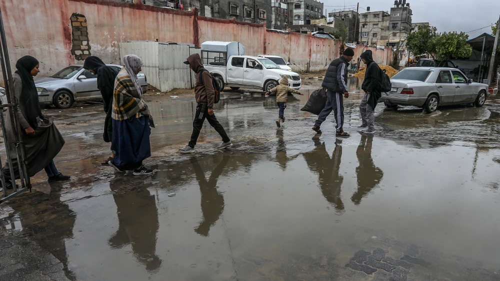 Palestinians walk through rainwater flooding the courtyards of Nasser Hospital in Khan Yunis, in the southern Gaza Strip, on March 26, 2026. Photo by Abed Rahim Khatib/Flash90.