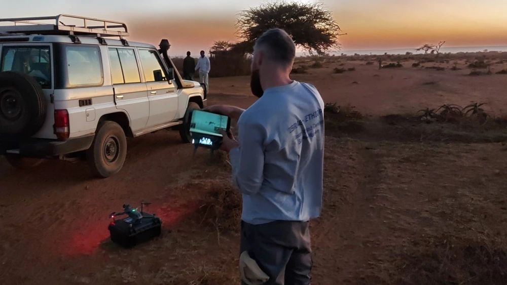 Tomer Regev using drones to track locust swarms in Ethiopia at dusk. Photo by Yoav Motro.