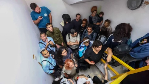 Israelis take cover inside a bomb shelter at Ben-Gurion International Airport as a siren alert is sounded, Oct. 1, 2024. Photo by Dor Pazuelo/Flash90.