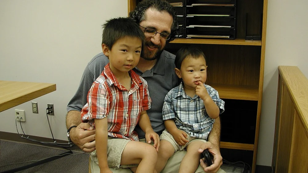 A father and his adopted sons. Photo by Brendon Connelly via Wikimedia Commons.