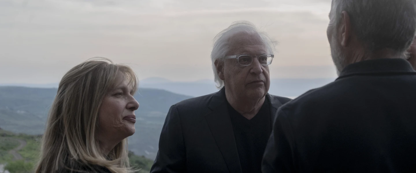 David and Tammy Friedman, facing camera, speak to an attendant of a ceremony held at Ein Kshatot, Israel on March 25, 2025. Photo by Canaan Lidor.