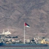 A picture taken from Israel's southern Red Sea resort city of Eilat shows the flag of the Arab Revolt flying in the Jordanian coastal city of Aqaba, Nov. 19, 2021. Photo by Ahmad Gharabli/AFP via Getty Images.
