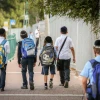 Israeli children wearing face masks make their way to school in Tzfat on their first day back to classes on Nov. 1, 2020. Photo by David Cohen/Flash90.