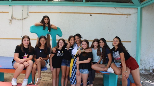 A group of 12-year-olds at the Yuvalei Ha-Bsor School summer camp with their senior adult educator (center) Limor Or, July 2019. Photo by Eric Narrow/JNF.