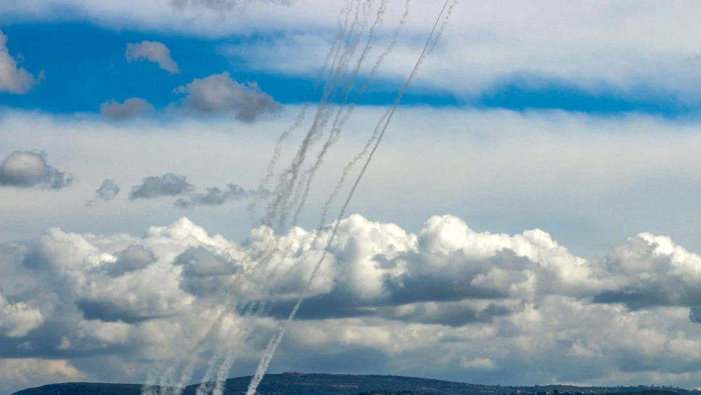Trails of rockets launched from Southern Lebanon towards Israel are pictured from the southern city of Tyre on March 25, 2026. Photo by Kawnat HAJU / AFP via Getty Images.