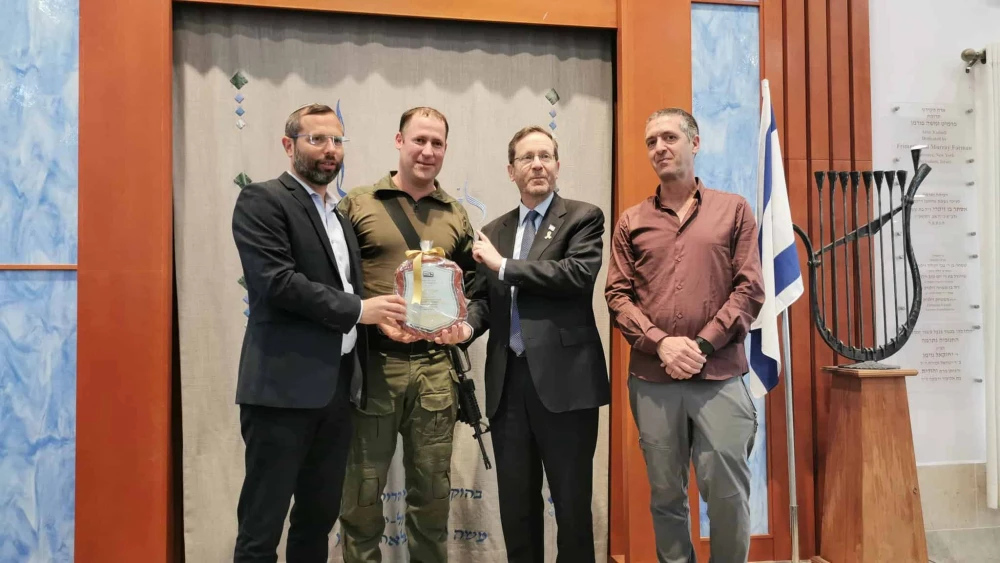 Aviad Gizbar (second from left) receives a certificate of appreciation from Israeli President Isaac Herzog and Binyamin Regional Council head Israel Ganz (left). Credit: Binyamin Regional Council.